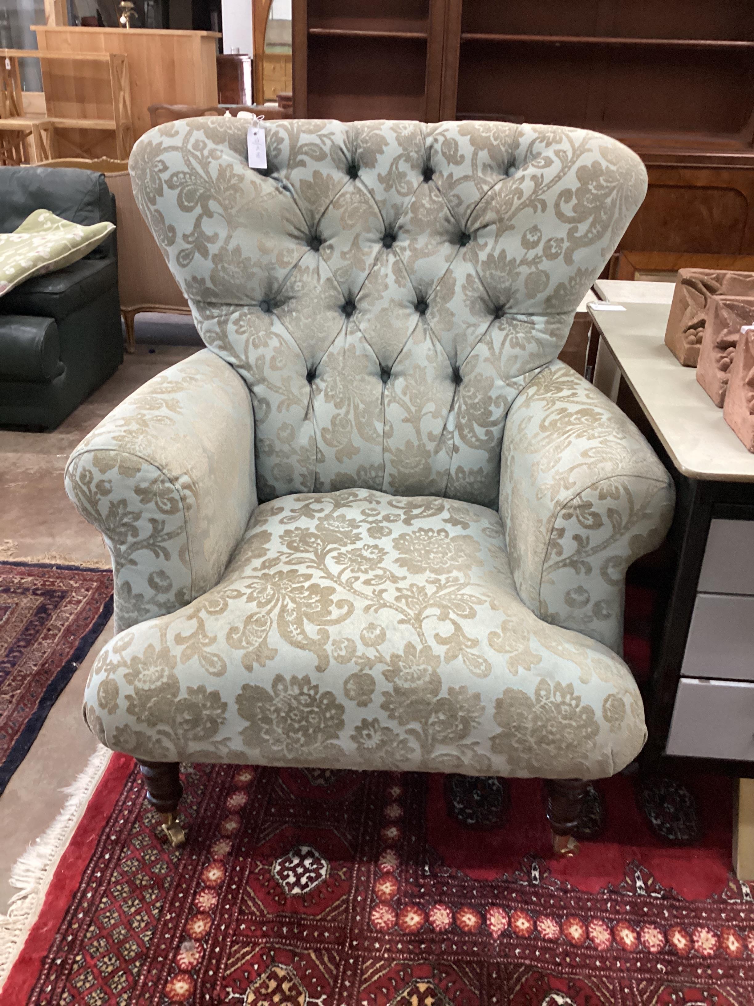 A modern upholstered armchair, width 92cm, depth 70cm, height 110cm